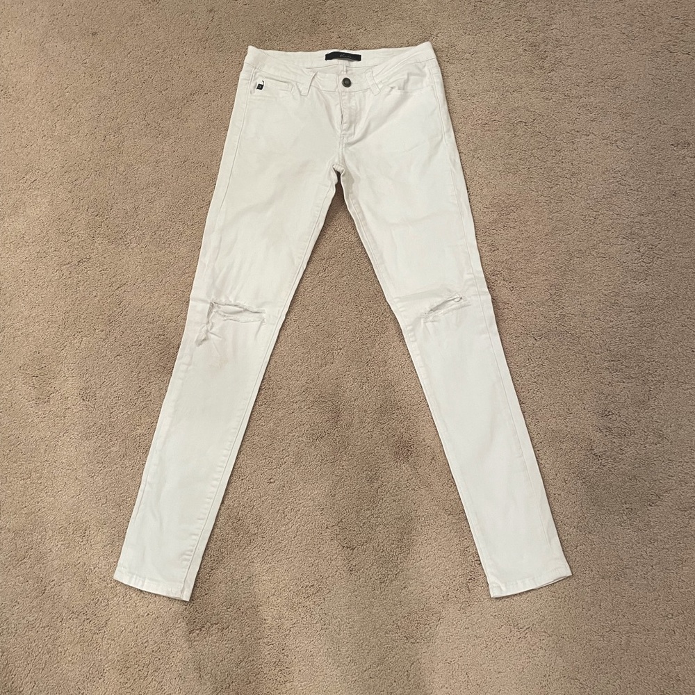 White skinny jeans ripped at the knees